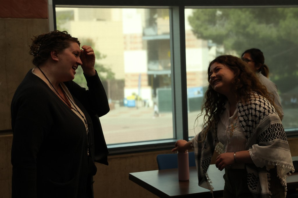 Two women happily talking with each other