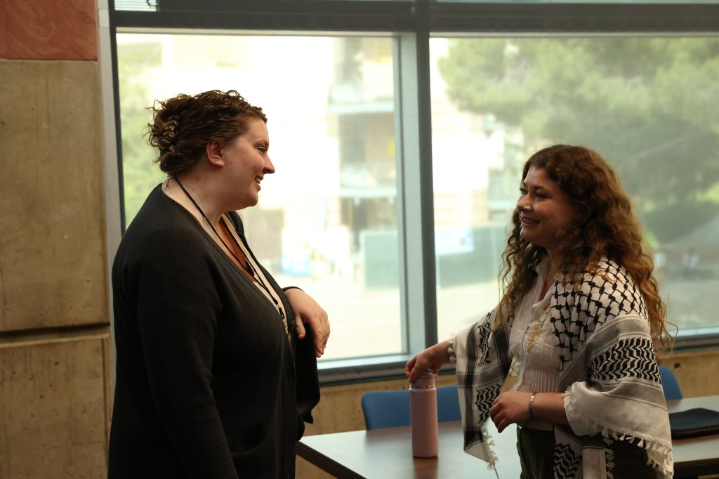 Two women happily talking with each other